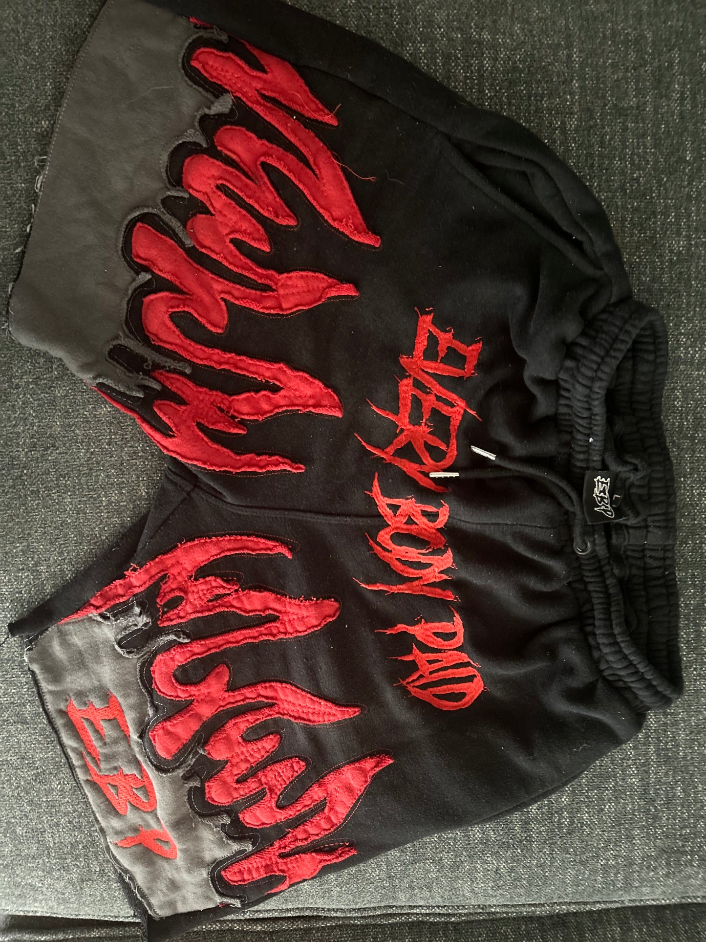 black Everybody Paid shorts with red flames